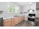 The well-lit kitchen features wood cabinets, stainless steel appliances, granite countertops, and a double sink at 3078 Alberta Dr, Marietta, GA 30062