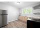 Modern kitchen with stainless steel refrigerator, wood cabinets, and dark countertops with great natural light at 3078 Alberta Dr, Marietta, GA 30062