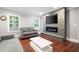 Cozy living room with hardwood floors, a modern fireplace, and large windows at 3078 Alberta Dr, Marietta, GA 30062