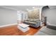 Open living room featuring hardwood floors, stone accent wall, and a modern white coffee table at 3078 Alberta Dr, Marietta, GA 30062