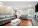 Bright living room with hardwood floors, comfortable seating, and a modern fireplace feature at 3078 Alberta Dr, Marietta, GA 30062