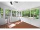 An airy screened porch featuring a wood floor, beadboard ceiling and wooded view at 3078 Alberta Dr, Marietta, GA 30062
