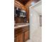 Wet bar area features dark wood cabinetry and stainless steel microwave at 4140 Lansfaire Ter, Suwanee, GA 30024