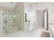 Bright bathroom with white cabinets, vanity, glass shower, and tiled floor at 4140 Lansfaire Ter, Suwanee, GA 30024