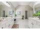 Large bathroom with white tile floor, double vanity, and a garden tub at 4140 Lansfaire Ter, Suwanee, GA 30024