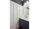 Stylish bathroom with board and batten detail, a modern vanity, and elegant mirror at 4140 Lansfaire Ter, Suwanee, GA 30024