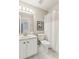Bright bathroom features a white vanity, framed mirror, and shower with a shower curtain at 4140 Lansfaire Ter, Suwanee, GA 30024