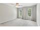 Bedroom featuring neutral carpet, ceiling fan, and two large windows with curtains at 4140 Lansfaire Ter, Suwanee, GA 30024