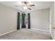 A serene bedroom with neutral tones, plush carpet, and natural light at 4140 Lansfaire Ter, Suwanee, GA 30024