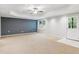 Expansive living area with large windows, recessed lighting, and neutral carpet at 4140 Lansfaire Ter, Suwanee, GA 30024