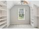 Walk-in closet with open shelving and storage, lit by a ceiling fan at 4140 Lansfaire Ter, Suwanee, GA 30024