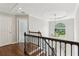 Foyer with hardwood floors, black iron railing, chandelier and large window at 4140 Lansfaire Ter, Suwanee, GA 30024