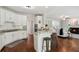 Modern kitchen featuring white cabinets, granite countertops, stainless steel appliances, and an open layout at 4140 Lansfaire Ter, Suwanee, GA 30024