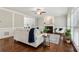 Welcoming living room with a fireplace, plush seating, hardwood floors, and large windows for natural light at 4140 Lansfaire Ter, Suwanee, GA 30024