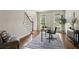 Home office featuring hardwood floors, natural light, and a workspace with a desk, chair, and area rug at 4140 Lansfaire Ter, Suwanee, GA 30024