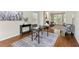 Inviting home office area featuring hardwood floors, natural light, desk space, and comfortable seating at 4140 Lansfaire Ter, Suwanee, GA 30024