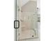 Close up of marble shower stall with a built-in seat and glass door at 4140 Lansfaire Ter, Suwanee, GA 30024