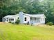 Charming ranch-style home with blue accents and a metal roof at 97 East Rd, Covington, GA 30016