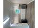 Kitchen featuring white cabinets, laminate floor, and stainless steel refrigerator at 97 East Rd, Covington, GA 30016
