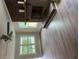 Living room featuring a brick fireplace, windows, and ceiling fan at 97 East Rd, Covington, GA 30016