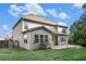 Large two-story home with fenced yard, a covered patio and lush lawn perfect for outdoor living and entertaining at 2113 Dodson Woods Dr, Fairburn, GA 30213