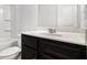Bathroom featuring dark vanity with white countertop, toilet, and shower with shelf at 2113 Dodson Woods Dr, Fairburn, GA 30213
