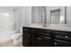 Bathroom featuring dark vanity with white countertop, toilet, and shower with shelf at 2113 Dodson Woods Dr, Fairburn, GA 30213