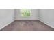 Spacious bedroom featuring neutral walls, carpet, and a window with blinds at 2113 Dodson Woods Dr, Fairburn, GA 30213