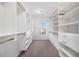Walk-in closet with custom shelving, drawers, and a window for natural light at 2113 Dodson Woods Dr, Fairburn, GA 30213