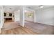 Spacious dining area with light hardwood floors and a view of the kitchen and front room at 2113 Dodson Woods Dr, Fairburn, GA 30213