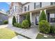 Close-up of home's entrance with stone accents and a well-manicured lawn and garden at 2113 Dodson Woods Dr, Fairburn, GA 30213