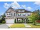 Charming two-story home featuring stone accents, manicured lawn, and an attached two-car garage at 2113 Dodson Woods Dr, Fairburn, GA 30213