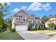 Beautiful two-story home with stone accents, a well-maintained lawn, and a spacious driveway at 2113 Dodson Woods Dr, Fairburn, GA 30213