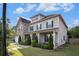 Stylish two-story house showcasing gray siding, stone accents, and lush green landscaping at 2113 Dodson Woods Dr, Fairburn, GA 30213