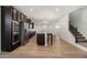 Open kitchen with a large island, stainless appliances, and wood-look flooring at 2113 Dodson Woods Dr, Fairburn, GA 30213