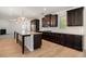 Spacious kitchen features an island with granite countertops, dark cabinets, and modern appliances at 2113 Dodson Woods Dr, Fairburn, GA 30213