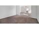 Spacious living room with neutral carpet and open doorway into another room at 2113 Dodson Woods Dr, Fairburn, GA 30213