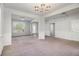 Bright and airy living room with white walls, neutral carpet, and elegant lighting fixtures at 2113 Dodson Woods Dr, Fairburn, GA 30213
