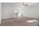 Large main bedroom with carpet, ceiling fan, tray ceiling, and ensuite bathroom at 2113 Dodson Woods Dr, Fairburn, GA 30213
