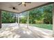 A covered back patio with ceiling fans for enjoying the outdoors, framed by lush landscaping and a well-manicured yard at 2113 Dodson Woods Dr, Fairburn, GA 30213
