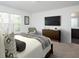 Airy bedroom with large windows, TV, and decorative accents, creating a stylish retreat at 410 Chaleur Way, Locust Grove, GA 30248