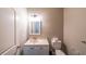 Cozy powder room features a single vanity and standard toilet at 6220 Polar Fox Ct, Riverdale, GA 30296