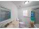 Bright bathroom features a single sink vanity, toilet, and shower/tub combo with modern gray tiling at 6220 Polar Fox Ct, Riverdale, GA 30296