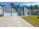 Charming two-story home featuring a two-car garage and long concrete driveway at 6220 Polar Fox Ct, Riverdale, GA 30296