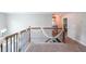 Hallway with wooden banister and neutral carpet floors at 6220 Polar Fox Ct, Riverdale, GA 30296