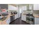 This well-appointed kitchen offers stainless steel appliances and granite countertops at 6220 Polar Fox Ct, Riverdale, GA 30296