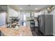 Well-lit kitchen features stainless steel appliances, tile backsplash, and white cabinetry at 6220 Polar Fox Ct, Riverdale, GA 30296
