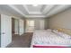 Inviting primary bedroom features a tray ceiling and an ensuite bath with soaking tub at 6220 Polar Fox Ct, Riverdale, GA 30296