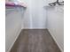 Neutral walk-in closet features carpet floors and shelving at 6220 Polar Fox Ct, Riverdale, GA 30296