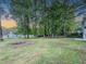 Spacious, fenced backyard with mature trees, offering privacy and room for recreation at 8007 Northcrest Dr, Jonesboro, GA 30238